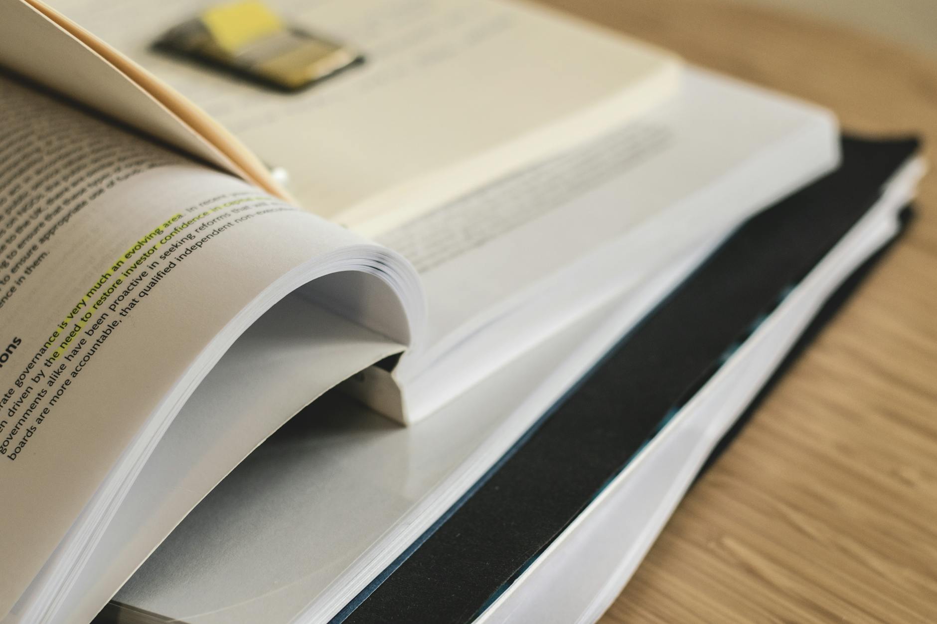 Pila di curriculum su scrivania con evidenziatore - screening parser CV ATS