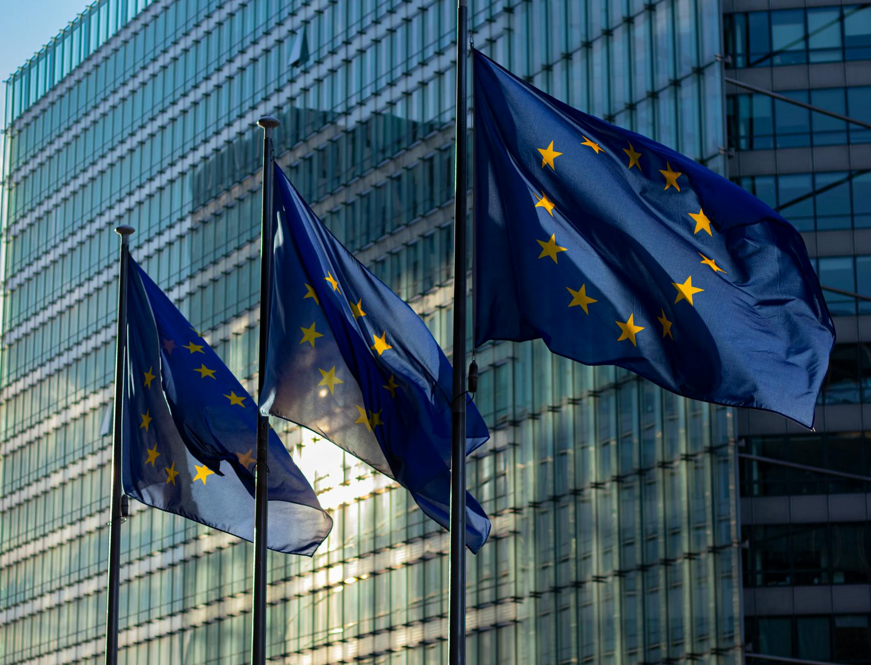 Bandiera europea davanti a edificio istituzionale, simbolo del quadro normativo GDPR e Schrems II per il consenso cookie
