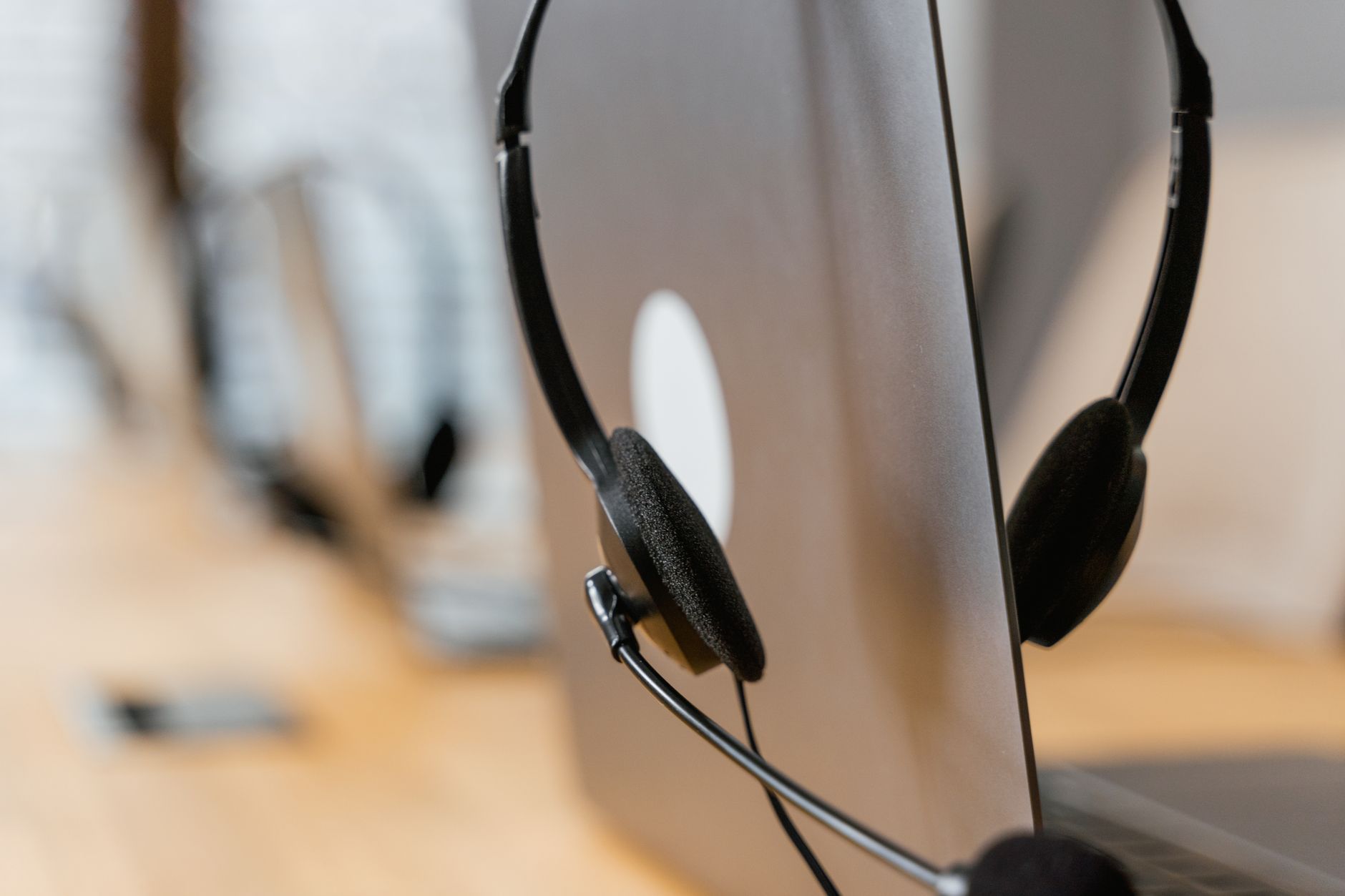 Specialista customer success italiano con cuffie alla scrivania assiste un cliente B2B